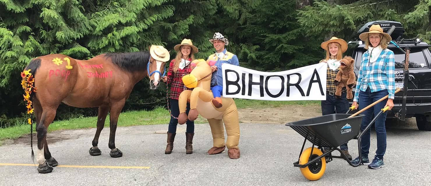 BIHORA members in costume with a decorated horse and BIHORA banner at a community parade on Bowen Island